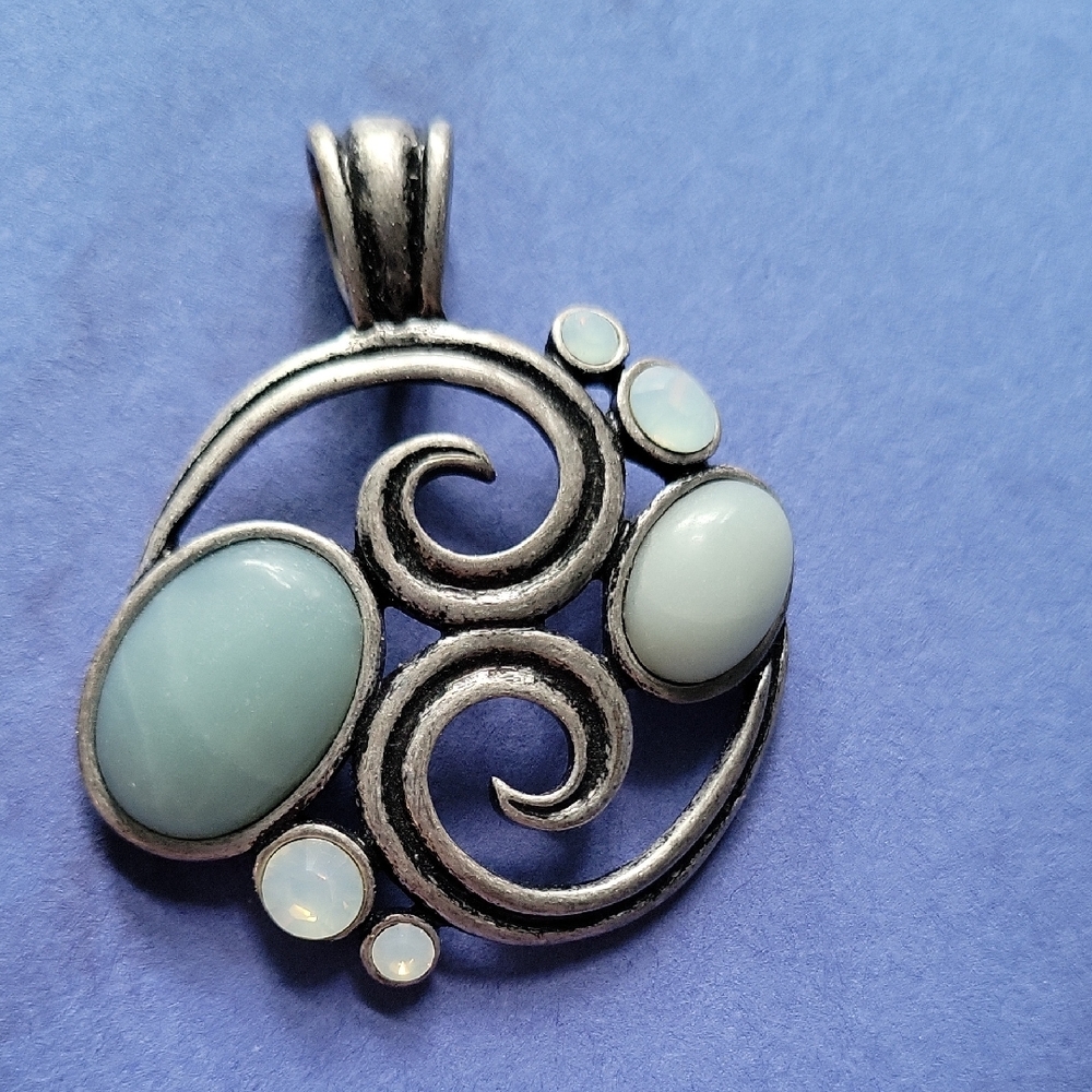 Elegant Silver Swirl Pendant with Blue Accents